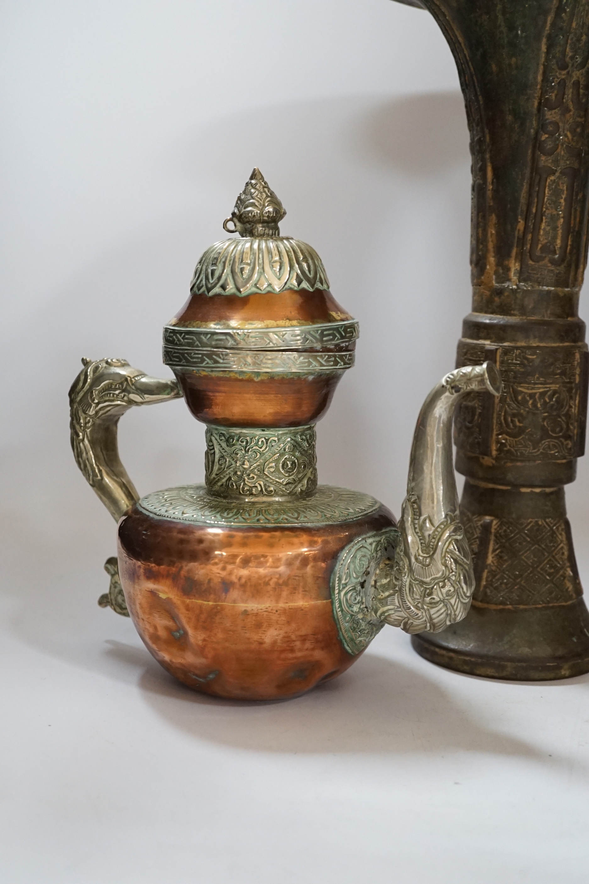 A Chinese bronze gu vase, a 19th century Chinese blue and white vase and a Tibetan teapot, tallest 34cm